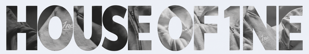 Large typographic artwork reading 'HOUSE OF 1' in black and gray letters, with textured fabric-like fill details inside the letters, on a very light gray background.